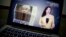FILE - An online video about U.S.-China trade tensions produced by China's state television broadcaster plays on a computer screen in Beijing, China, Aug. 23, 2018. 