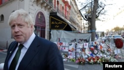London Mayor Boris Johnson leaves after placing flowers at the Bataclan concert hall to pay tribute to the shooting victims in Paris, France, Dec. 3, 2015. Johnson said on Jan. 5, 2016, that a small child shown threatening non-Muslims in a grisly Islamic State video should be taken from his parents if the family ever returns to Britain.