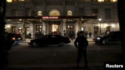 An Austrian police officer stands outside Hotel Imperial in Vienna, site of talks on the Syrian crisis, Nov. 13, 2015.