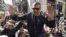 FILE - Algerian journalist Khaled Drareni is carried by protesters on their shoulders after he was briefly detained by security forces in Algiers, March 6, 2020.