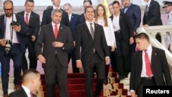 Venezuela's opposition leader Juan Guaido, center right, whom many nations have recognized as the country's rightful interim ruler, and Paraguay's President Mario Abdo Benitez are pictured after a meeting at the Lopez Palace in Asuncion, Paraguay, March 1, 2019.