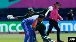 India's Hardik Pandya prepares to throw the ball as Pakistan's Usman Khan defends the wicket during the ICC men's Twenty20 World Cup 2024 group A cricket match between India and Pakistan at Nassau County International Cricket Stadium in East Meadow, New Y