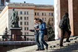 FILE - Students walk outside the main building of Moscow State University, in Moscow, Russia, Feb. 10, 2015.