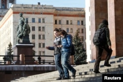 FILE - Students walk outside the main building of Moscow State University, in Moscow, Russia, Feb. 10, 2015.