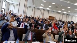 FILE - Somali parliament members raise up their hands to vote, in Mogadishu, Somalia, Sept. 23, 2020. Somalia's prime minister this month announced a 30 percent quota for female lawmakers chosen in upcoming elections. 