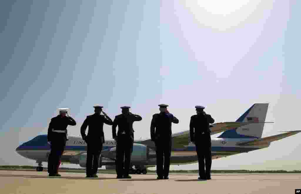 President Barack Obama is celebrating Earth Day with a visit to the Everglades to talk about how global warming threatens the U.S. economy. In this photo, military personnel salute as Air Force One departs with the president aboard from Andrews Air Force Base, Maryland on its way to the Everglades, April 22, 2015.