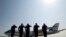 President Barack Obama is celebrating Earth Day with a visit to the Everglades to talk about how global warming threatens the U.S. economy. In this photo, military personnel salute as Air Force One departs with the president aboard from Andrews Air Force Base, Maryland on its way to the Everglades, April 22, 2015.