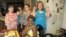 Madison Blandford (far left) and her classmates and neighbors show off their Ugandan beads at Madison's recent jewelry party. (VOA/F. Elmasry)