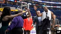 Brooklyn Nets center Jason Collins, right, is congratulated by fans after they defeated the Los Angeles Lakers in an NBA basketball game, Sunday, Feb. 23, 2014.