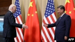 U.S. President Joe Biden greets Chinese President Xi Jinping on the sidelines of the Asia-Pacific Economic Cooperation summit in Lima, Peru, on Nov. 16, 2024.