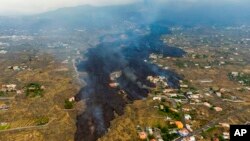 Lava from a volcano eruption flows destroying houses on the island of La Palma in the Canaries, Spain, Sept. 21, 2021.