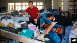 Palestinian postal workers sift through eight years' worth of undelivered mail held by Israel, at the post office in the West Bank city of Jericho, Aug. 19, 2018.