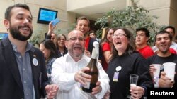 FILE - Members of the activist group Motion of Integration and Gay Liberation celebrate the congressional passage of a bill recognizing civil unions in Valparaiso, Chile, Jan. 28, 2015. Registration of such unions begins this week.