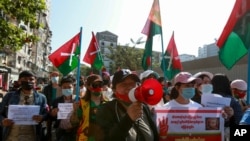 Demonstrators display ethnic Kachin flags during a protest in Yangon, Myanmar, Wednesday, Feb. 10, 2021. Protesters continued to gather Wednesday morning in Yangon breaching Myanmar's new military rulers' decrees that effectively banned peaceful…