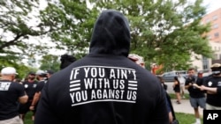 FILE - Denver Broncos linebacker Von Miller displays a message on the back of his hoodie as he takes part in a Black Lives Matter rally with teammates at Civic Center Park, in downtown Denver, Colorado, June 6, 2020.