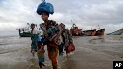 FILE — Displaced families arrive after being rescued by boat from a flooded area of Buzi district, 200 kilometers (120 miles) outside Beira, Mozambique, Saturday, March 23, 2019.