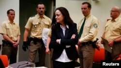 Beate Zschaepe, a member of the neo-Nazi group National Socialist Underground (NSU) stands in the court before the start of her trial in Munich, May 6, 2013. 