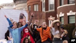 Girls dance to amplified music for Purim, Feb. 26, 2021, in the Crown Heights neighborhood of New York. The Jewish holiday of Purim commemorates the Jews' salvation from genocide in ancient Persia, as recounted in the Book of Esther. 