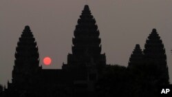 In this Friday, March 20, 2015, file photo, the sun rises behind Angkor Wat at the eastern site of Siem Reap province, some 230 kilometers (143 miles) northwest of Phnom Penh, Cambodia. Visitors who dress immodestly will not be allowed to enter Cambodia's