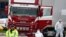 FILE - Police forensic officers attend the scene after a truck was found to contain a large number of dead bodies, in Grays, South England,Oct. 23, 2019.