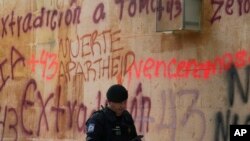 ARCHIVO - Un agente de seguridad pasa frente a la embajada de Israel, pintada por manifestantes que exigían la extradición del exdirector de la Agencia de Investigación Criminal de México, Tomás Zeron, el 21 de septiembre de 2022.