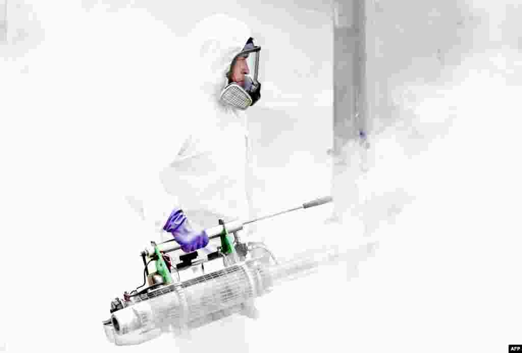 A municipal employee takes part in a disinfection operation against COVID-19 in San Jose, Costa Rica, on July 2, 2020. 