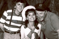 FILE - In this 1965 file photo, Dawn Wells, center, poses with fellow cast members of "Gilligan's Island," Bob Denver and Alan Hale Jr., in Los Angeles.