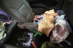 Belongings stained with blood are seen inside a bullet-riddled vehicle that members of LeBaron family were traveling in, on a dirt road in Bavispe, at the Sonora-Chihuahua border, Mexico, Nov 6, 2019.