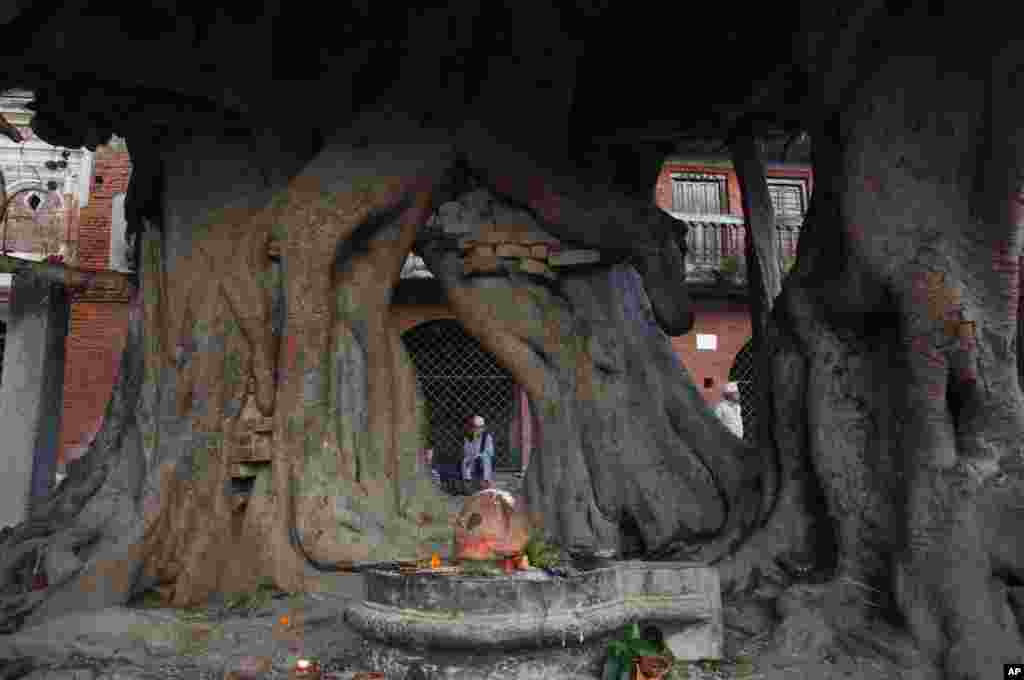 A Nepalese man rests after performing rituals during Kuse Aunsi, or Nepalese Father&rsquo;s day at the Gokarneshwar Hindu temple in Kathmandu. 