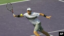 Mardy Fish returns a shot to David Ferrer at the Sony Ericsson Open tennis tournament in Key Biscayne, Fla., where Fish won the match 7-5, 6-2, March 30, 2011