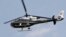 A police helicopter flies as police officers boost security around a new memorial in the center of Tahrir Square in Cairo, Nov. 18, 2013.