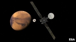 The ExoMars Trace Gas Orbiter and its entry, descent and landing demonstrator module, Schiaparelli are seen approaching Mars. The separation is scheduled to occur, Oct. 16, 2016, about seven months after its launch. (Courtesy - ESA/ATG medialab)