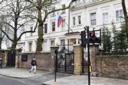 FILE - A Russian flag flies outside Russia's embassy in central London, Britain, March 15, 2018.