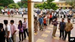 Cambodians wait on a line before they vote at a polling station in Phnom Penh, Cambodia, Sunday, July 27, 2008. 