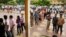 Cambodians wait on a line before they vote at a polling station in Phnom Penh, file photo. 