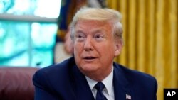 President Donald Trump listens as he receives a briefing on the 2020 hurricane season in the Oval Office of the White House, Thursday, May 28, 2020, in Washington. (AP Photo/Evan Vucci)