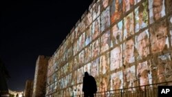 FILE —Photographs of Israeli hostages being held by Hamas militants are projected on the walls of Jerusalem's Old City, Monday, Nov. 6, 2023.