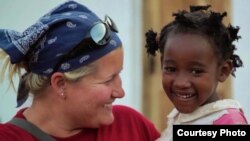 Ashley Holmer with Amina, a young community member from Mungere Village (Red Sweater Project)