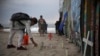 FILE- Candles are placed next to the border fence that separates Mexico from the U.S., in memory of migrants who have died during their journey toward the U.S., in Tijuana, Mexico, June 29, 2019. 