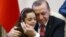 Turkey's President Recep Tayyip Erdogan, embraces Bana Al-Abed, 7, from Aleppo, Syria, at his Presidential Palace in Ankara, Dec. 21, 2016.