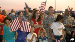 FILE - U.S. Air Force personnel and their families wait for the arrival of Airman 1st Class Spencer Stone, one of three Americans who tackled a heavily armed gunman on a Paris-bound train, at Travis Air Force Base in Fairfield, California, Sept. 3, 2015. 