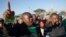Mineworkers dance as they gather for check-ins near Lonmin's Marikana platinum mine before returning to work, June 25, 2014. 