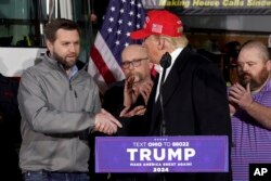 FILE - Former President Donald Trump greets Sen. JD Vance, R-Ohio, at the East Palestine Fire Department as he visits the area in the aftermath of the Feb. 3, 2023, Norfolk Southern train derailment in East Palestine, Ohio, Feb. 22