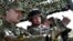 Ukrainian President Petro Poroshenko, left, watches a military exercise of the Ukrainian armed forces in Mykolaiv region, April 25, 2015.