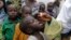 FILE - A health official administers a polio vaccine to children at a camp for people displaced by Islamist Extremist in Maiduguri, Nigeria, Aug. 28, 2016. 