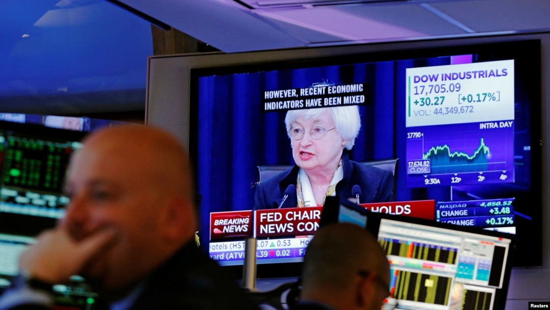 Traders work as Federal Reserve Chair Janet Yellen speaks on a television above the floor of the New York Stock Exchange (NYSE) shortly after the opening bell in New York City, U.S., June 15, 2016