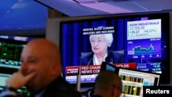 Traders work as Federal Reserve Chair Janet Yellen speaks on a television above the floor of the New York Stock Exchange (NYSE) shortly after the opening bell in New York City, U.S., June 15, 2016