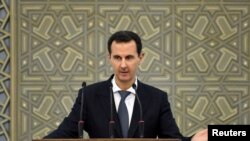 FILE - Syria's President Bashar al-Assad speaks during a meeting with heads of local councils, in Damascus, Syria, Feb. 17, 2019.