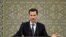 FILE - Syria's President Bashar al-Assad speaks during a meeting with heads of local councils, in Damascus, Syria, Feb. 17, 2019.