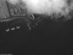 The Asia Bridge is shown loading coal at the Nampo, North Korea, coal berth on Aug. 9, 2019 (Photo courtesy of Royal United Services Institute)